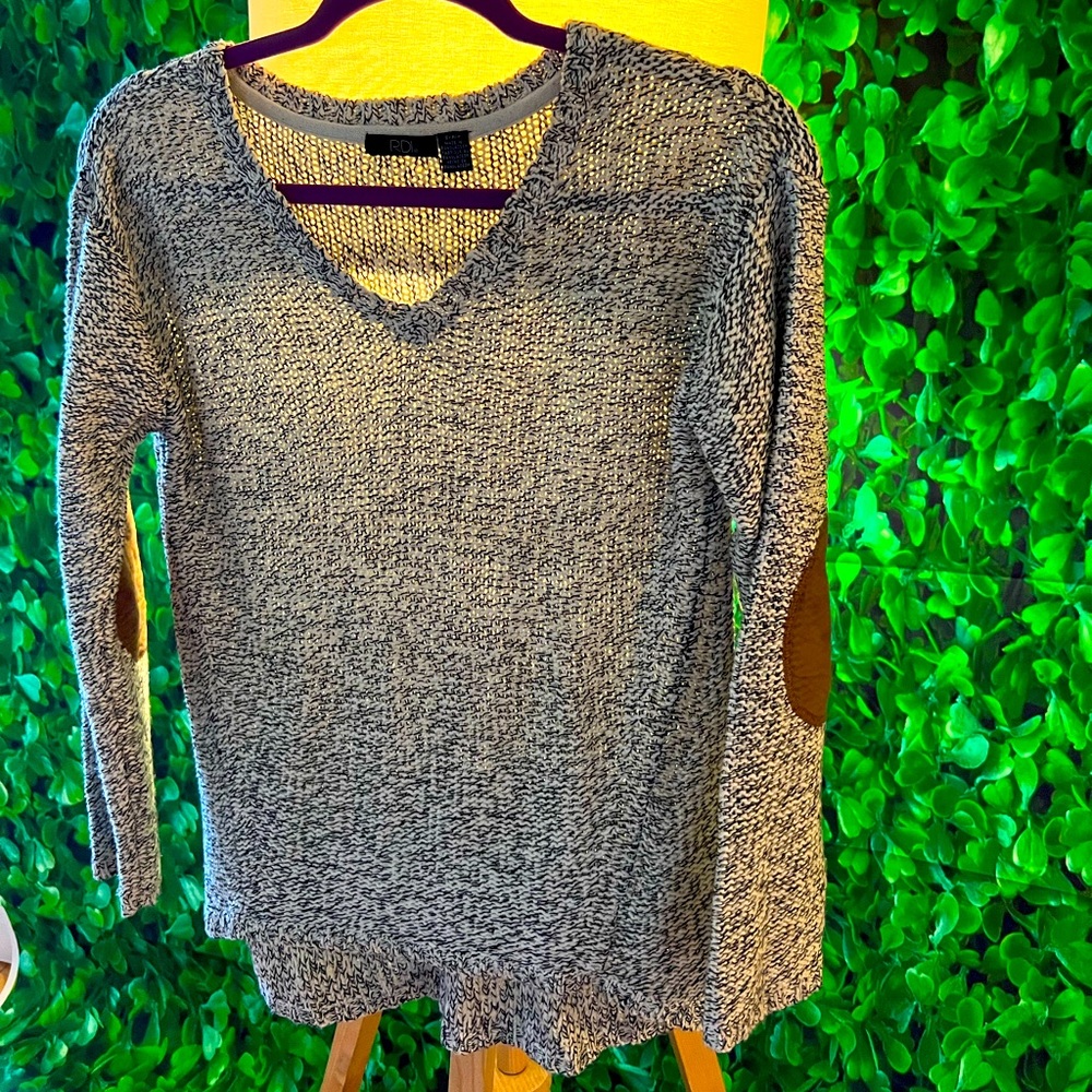 Knit sweater with brown suede patches on both elbows.